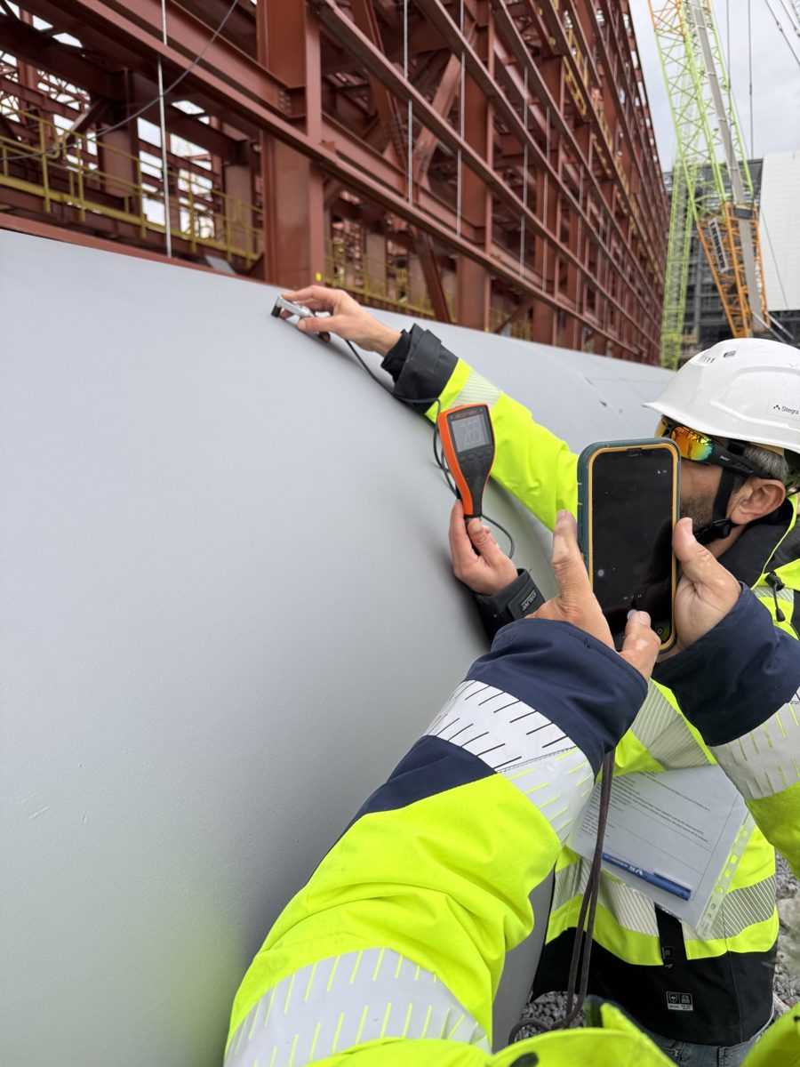 Inspectors checking a welded component on site