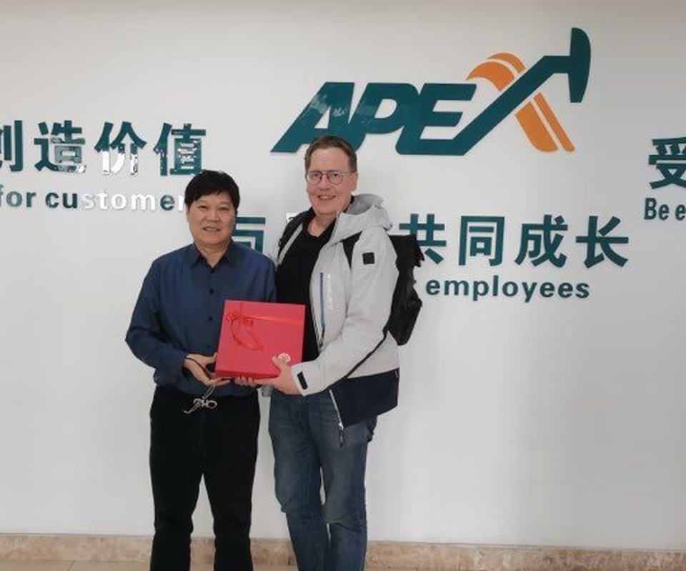 Otto with a supplier representative in China, exchanging a gift